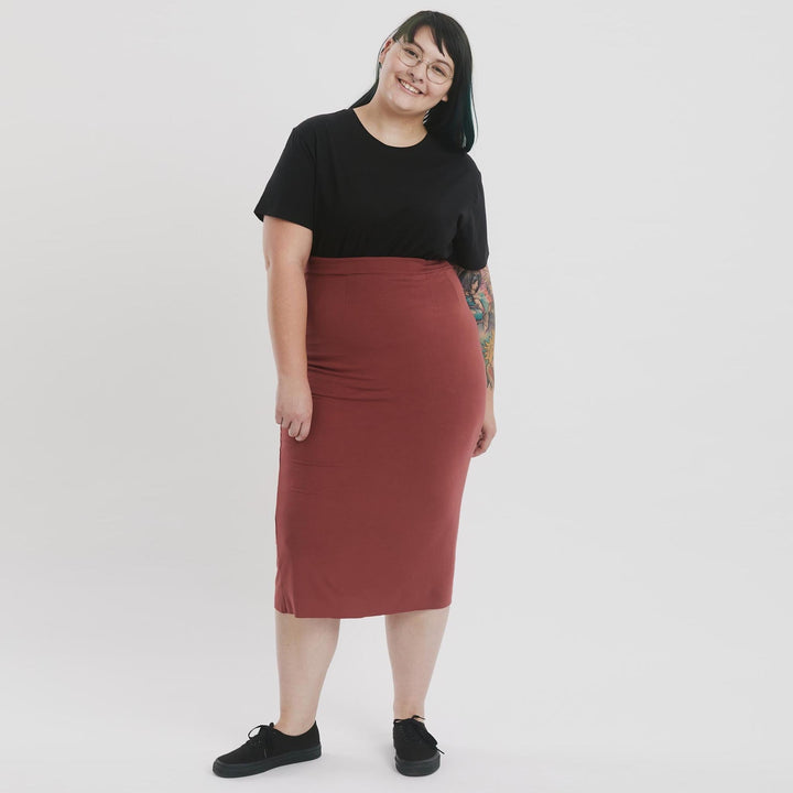 High-waisted pencil skirt from The Shapes United, showcasing a sleek, fitted clothing item in a neutral fabric.
