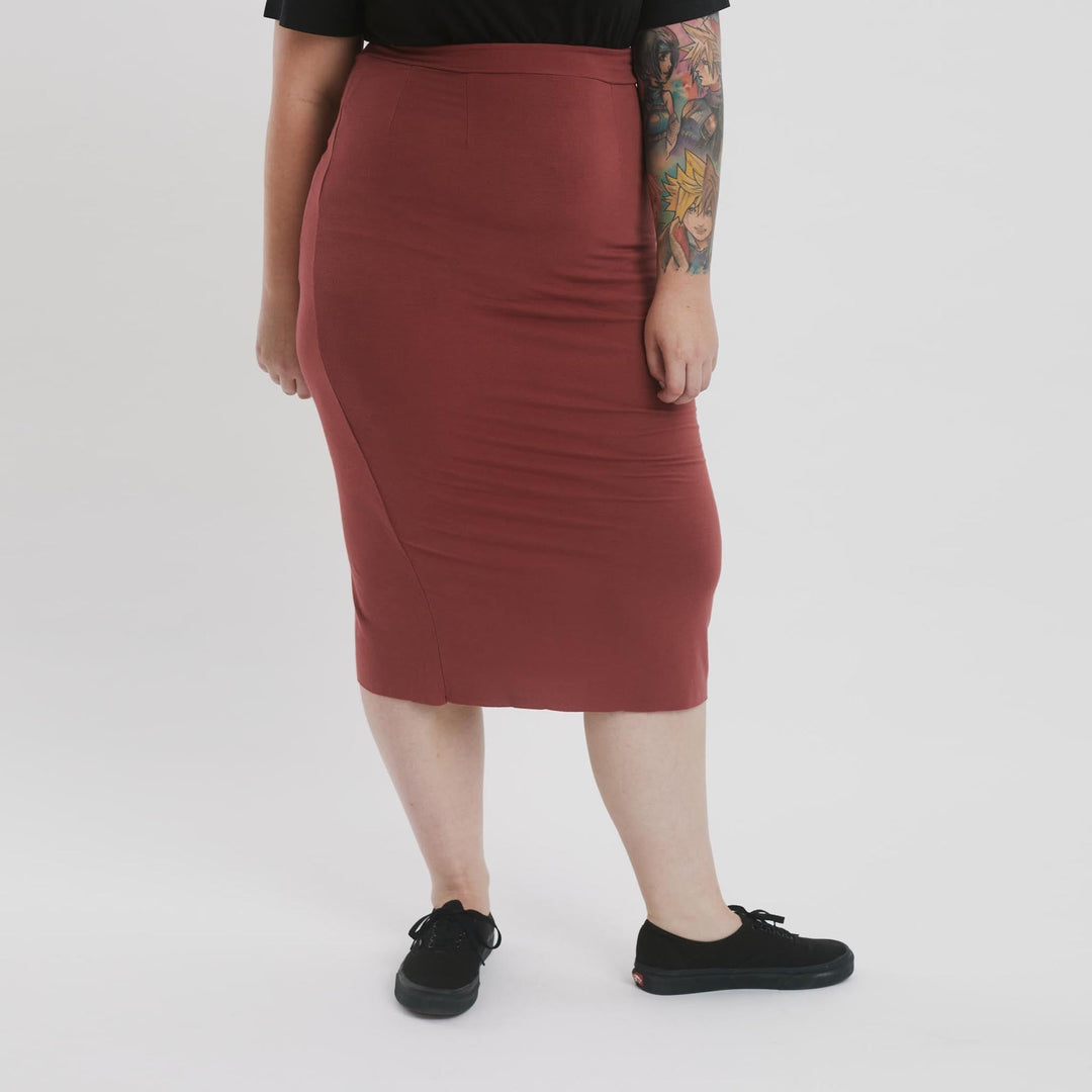High-waisted pencil skirt from The Shapes United, made of sleek, fitted clothing fabric, styled for a modern, professional look.