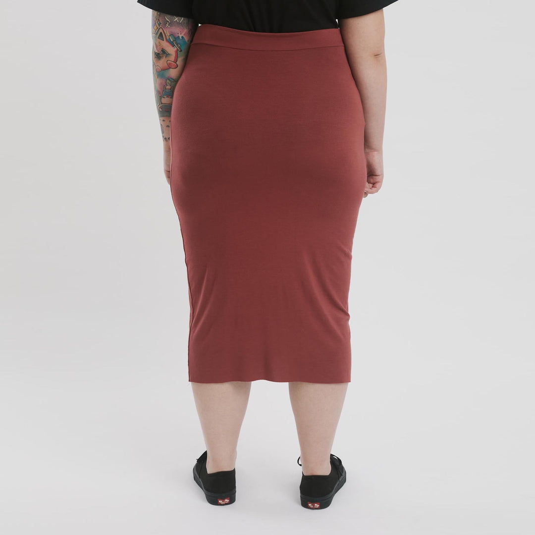 High-waisted pencil skirt by The Shapes United, showcasing a fitted silhouette and classic design in a neutral fabric.