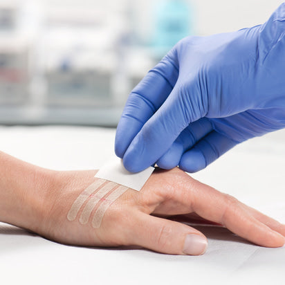 MoliCare Omnistrip Closure Strips for wound care, showing flexible adhesive strips in a clean, clinical setting.