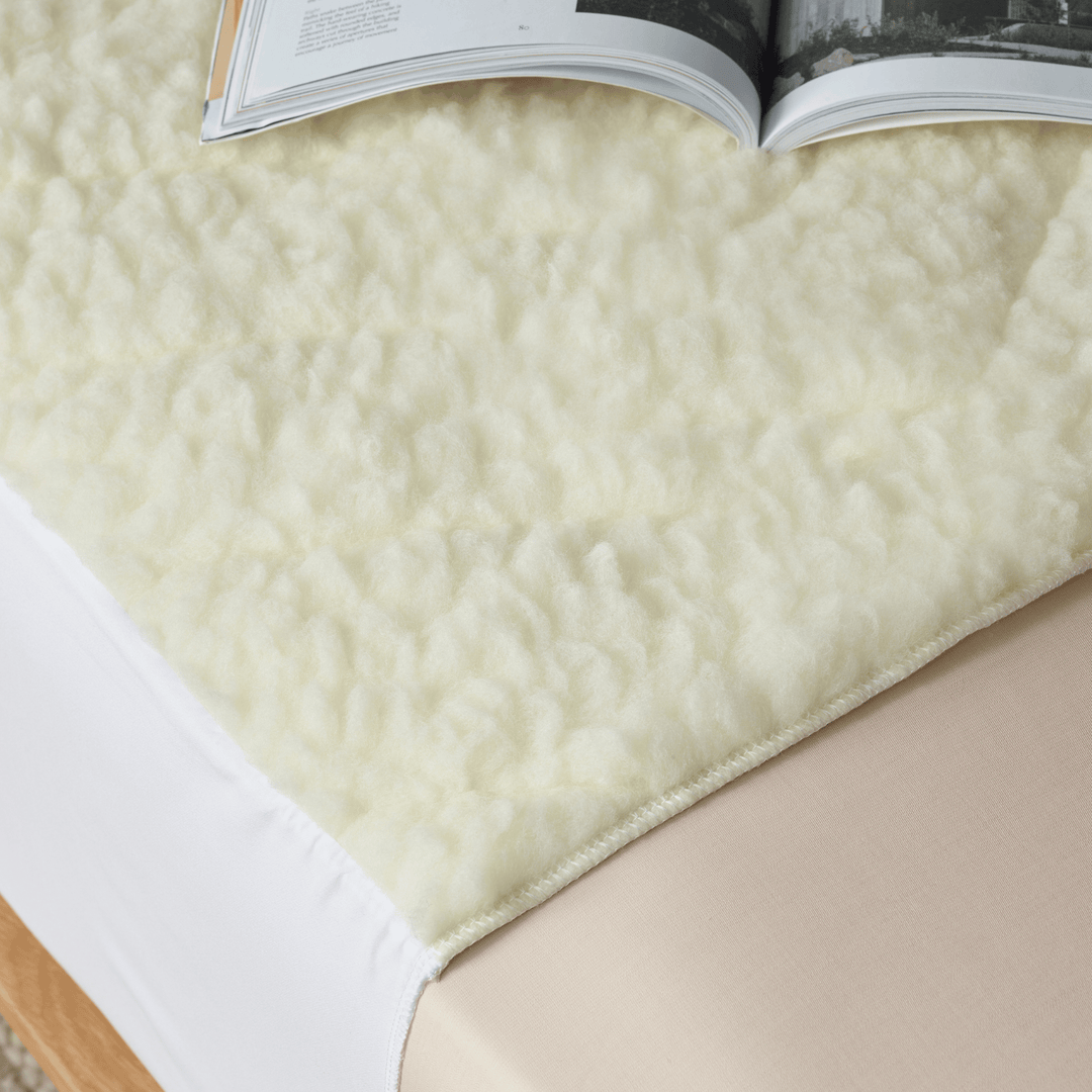 Staydry Wool Topper Bed Pad in a cozy, soft texture with a natural wool finish, perfect for comfortable bedding.