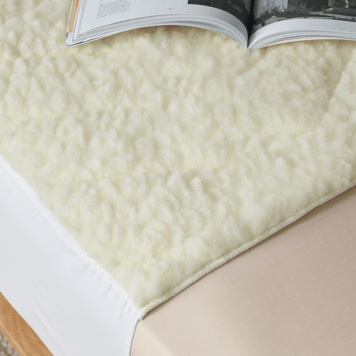 Staydry Wool Topper Bed Pad in a cozy, soft texture with a natural wool finish, perfect for comfortable bedding.