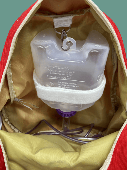 Tubie Fun Modified Backpack for nutrition, featuring adjustable straps and multiple pockets for medical feeding supplies.