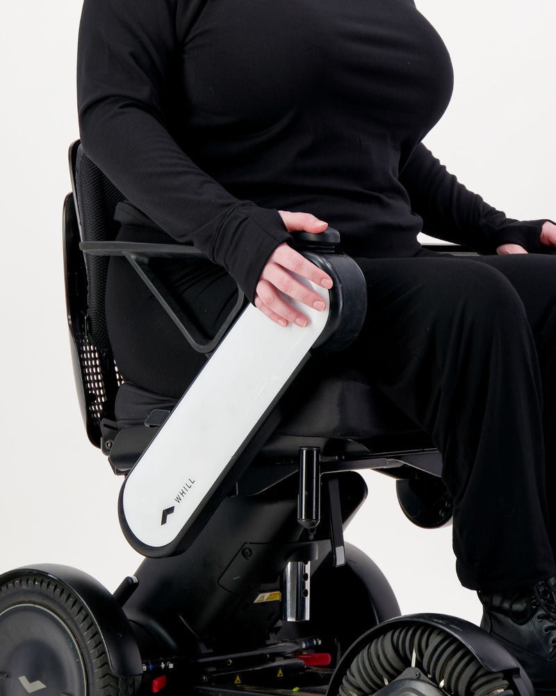 Our seated model with red hair and who is in a wheelchair is wearing a black thermal top with long sleeves, black pants and black boots. Christina Stephens Adaptive Clothing Australia.