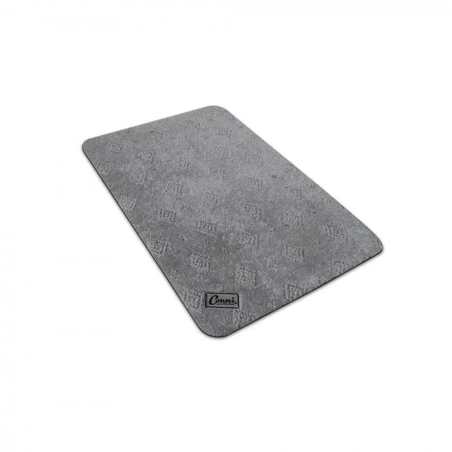 Conni Manchester compact floor mat in beige with textured surface, ideal for home or office use.