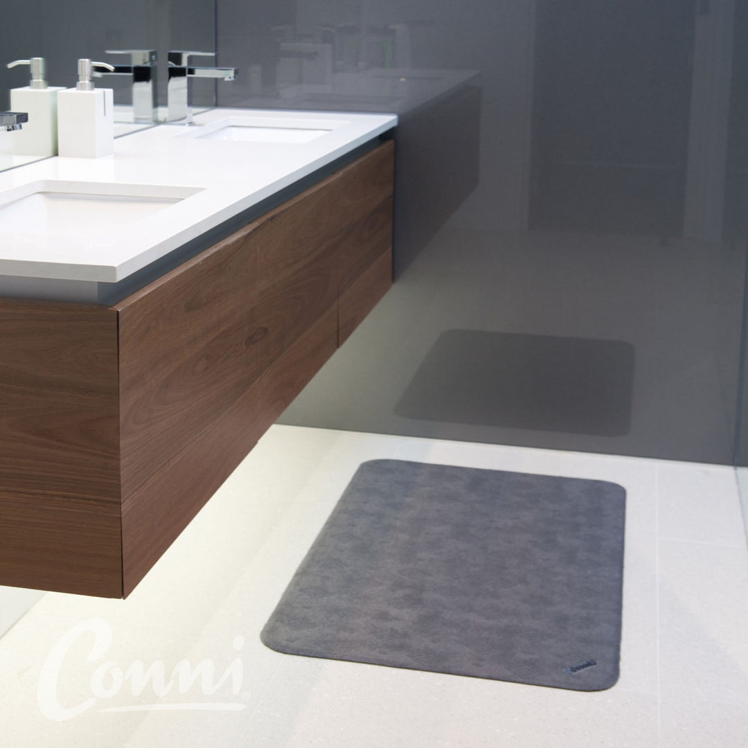 Conni classic grey anti-slip and absorbent Manchester floor mat with textured surface for safety and comfort.