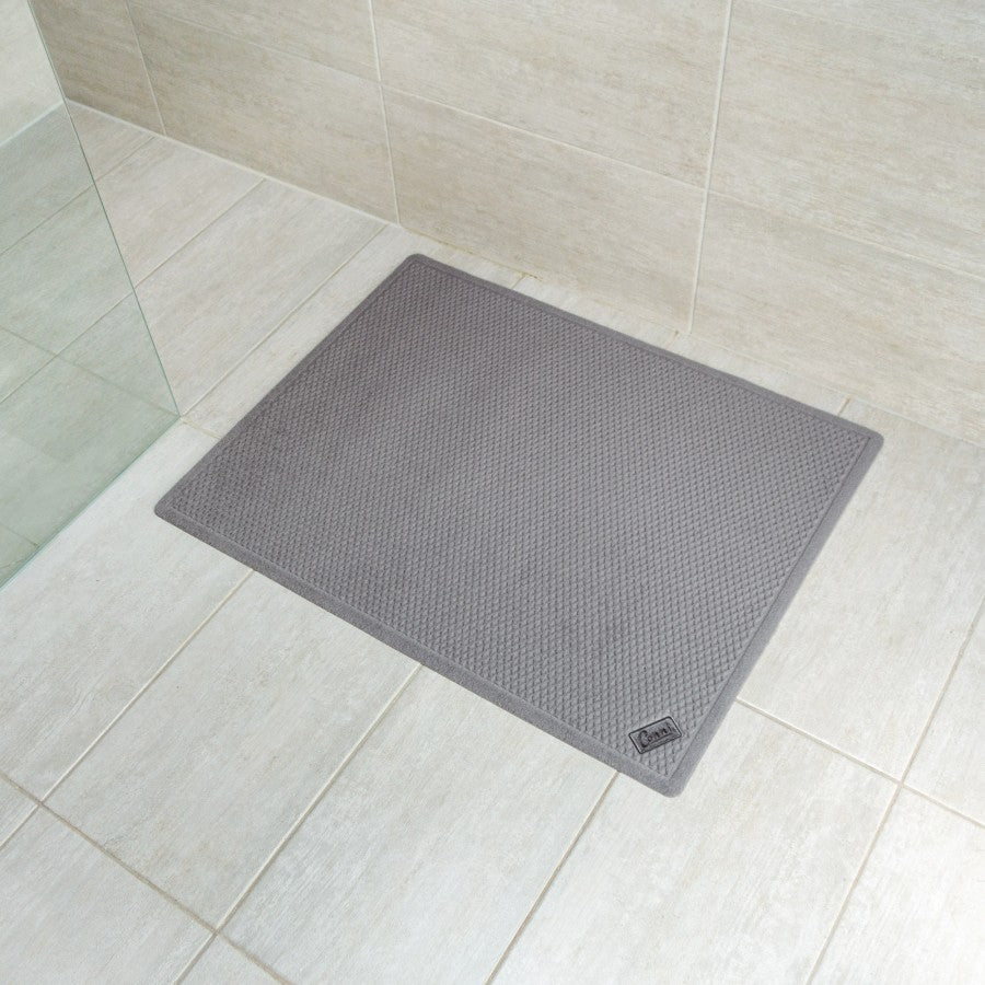 Grey Conni anti-slip and absorbent waffle Manchester floor mat with textured surface for safety and moisture absorption.