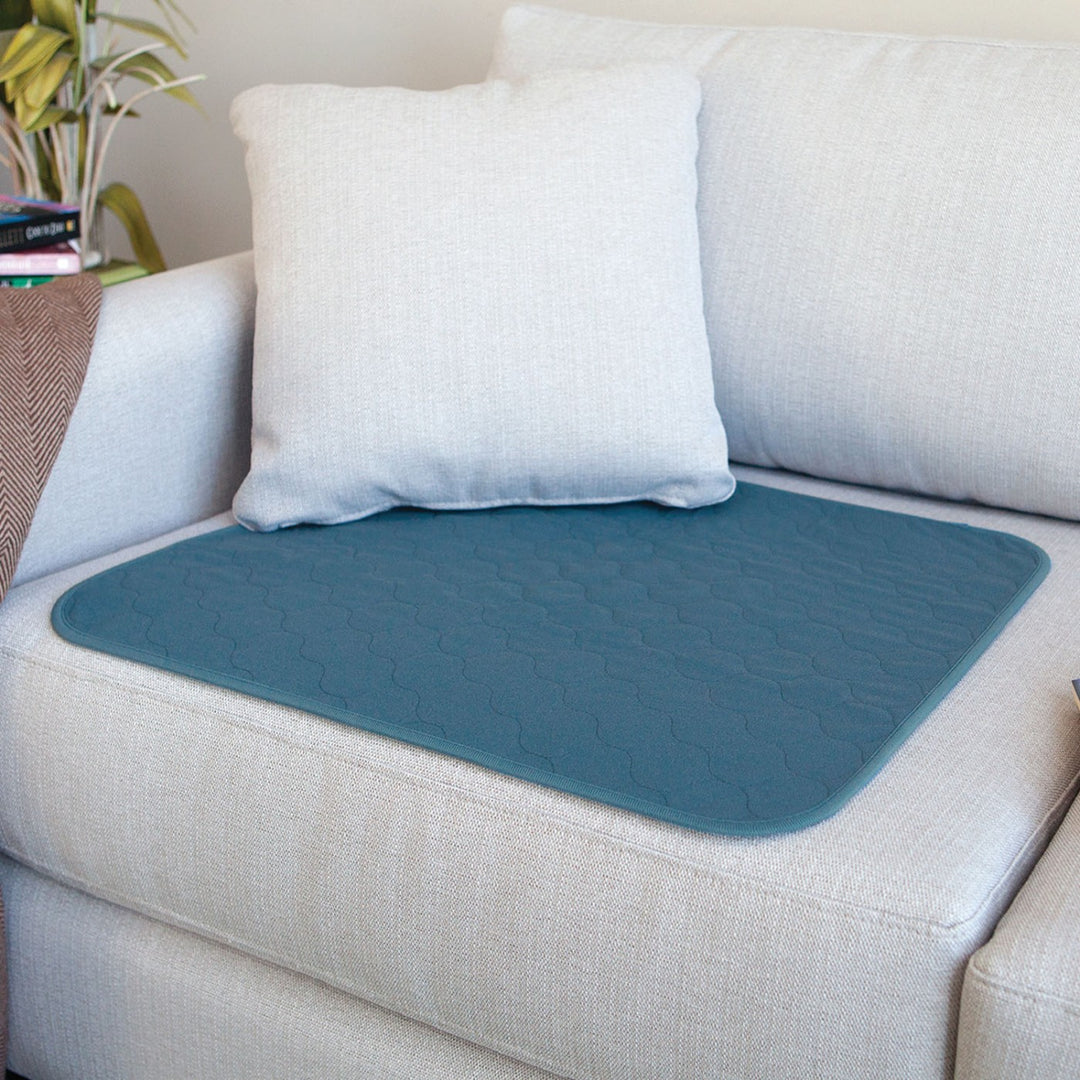 Large teal Conni chair pad with a soft fabric texture, designed for comfort and style in any seating area.