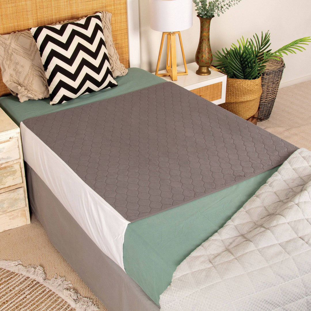 Conni plush top bed pad with tuck-ins, soft Manchester bedding in light grey, designed for comfortable sleep.