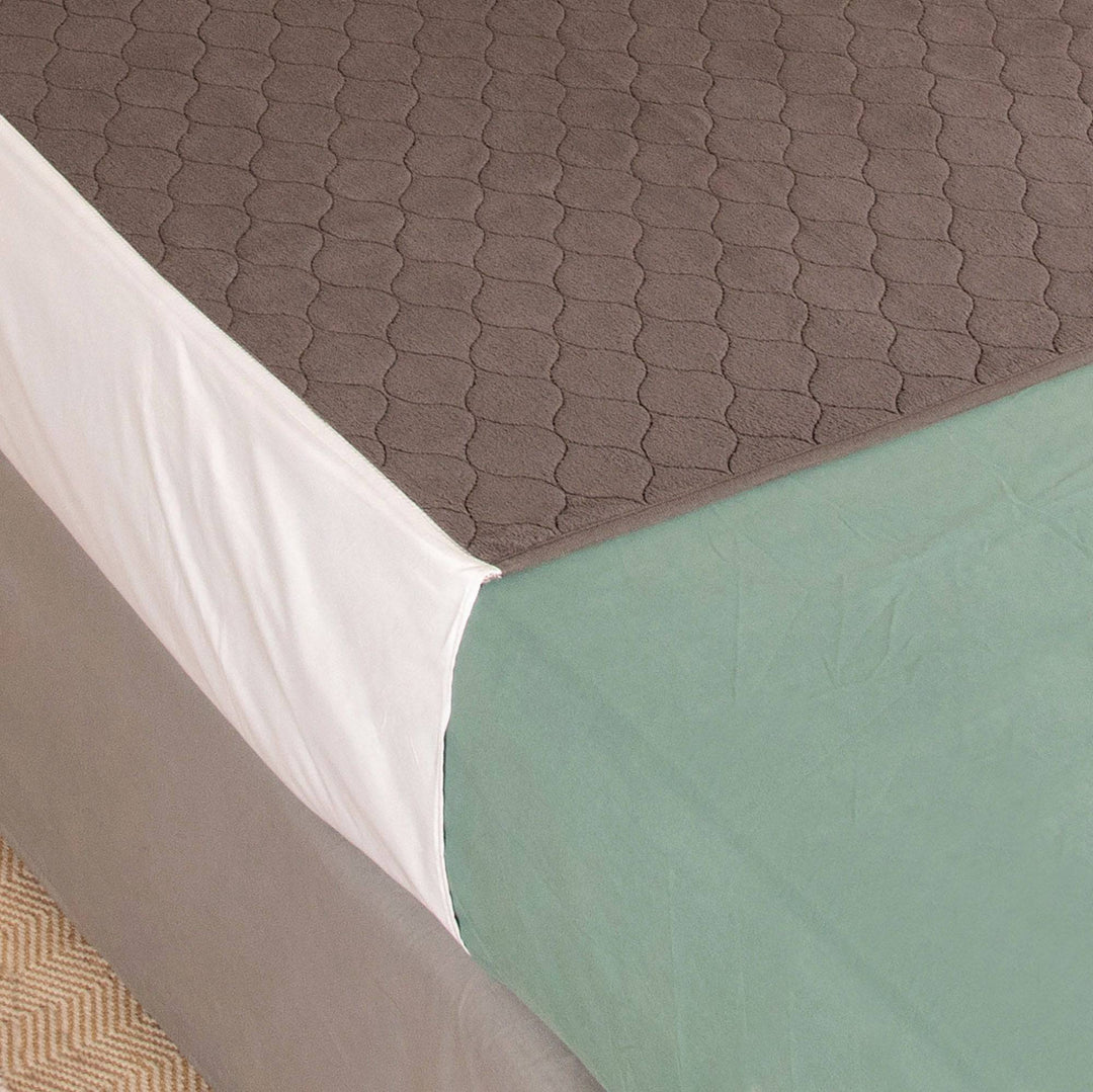 Conni plush top bed pad with tuck-ins, soft Manchester bedding in blue, designed for comfort and secure fit.