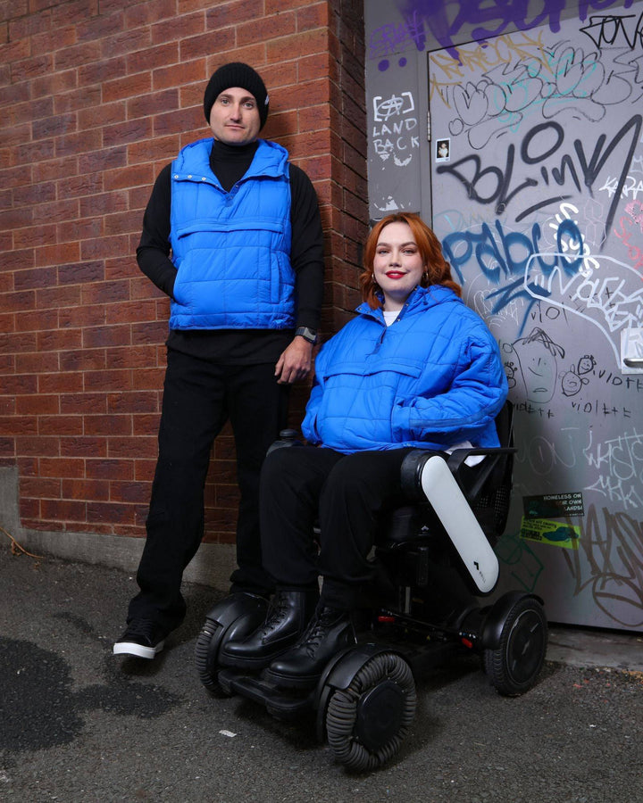 Blue adaptive puffer jacket by Christina Stephens designed for wheelchair users, showcasing a comfortable and functional fit.