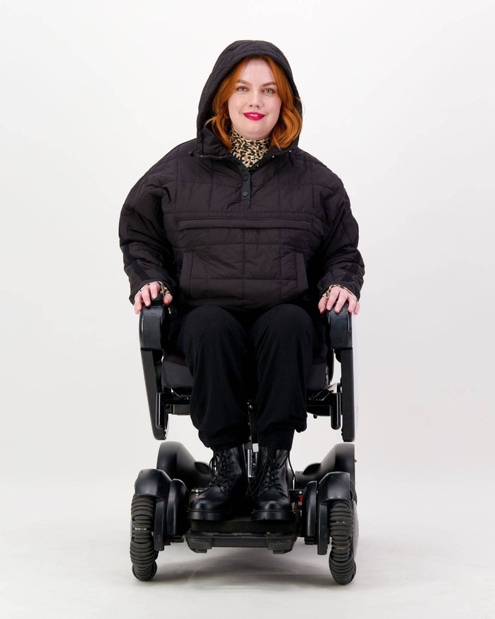 Black Elly Universal Adaptive Puffer Jacket by Christina Stephens designed for wheelchair users, showcasing its versatile fit.