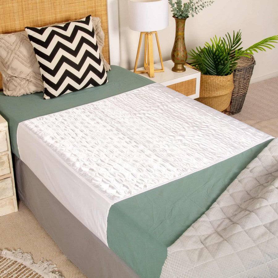 Conni Satin-Glide Manchester bed pad with tuck-ins, white, designed for added comfort and protection during sleep.
