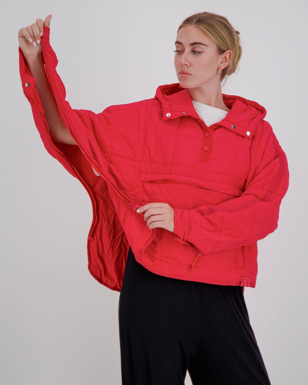 Red adaptive puffer jacket by Christina Stephens designed for wheelchair users, featuring a comfortable and stylish fit.