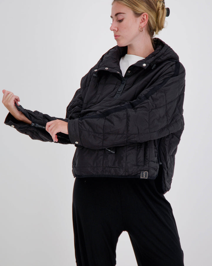 Black Elly Universal Adaptive Puffer Jacket by Christina Stephens designed for wheelchair users, showcasing its stylish cut and features.