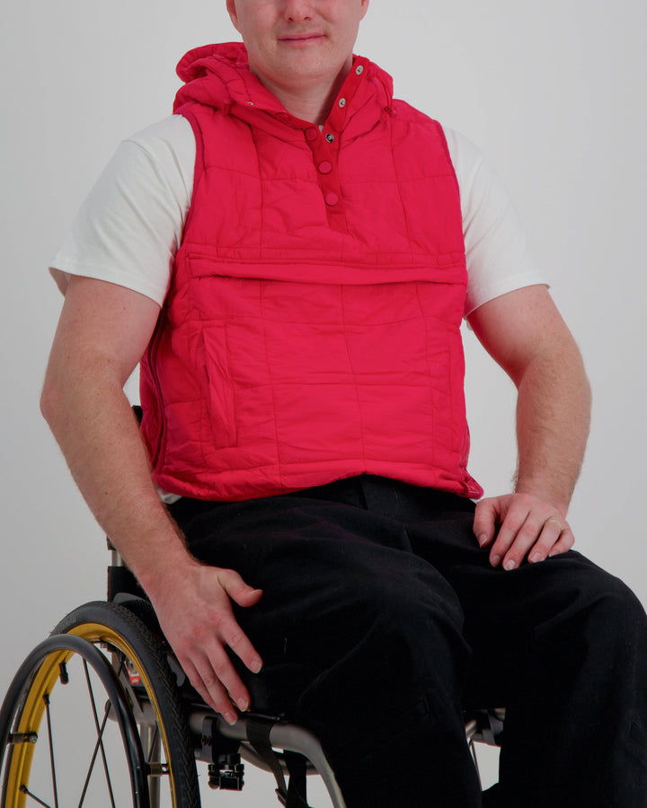 Red adaptive puffer vest by Christina Stephens, designed for wheelchair users with a gender-neutral fit and universal design.
