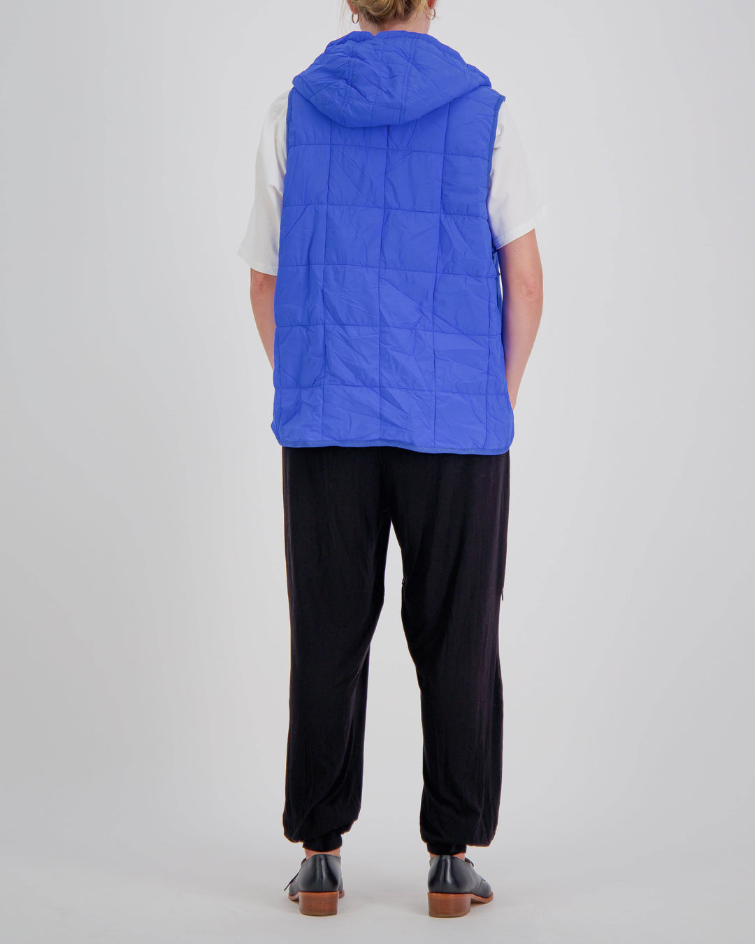 Blue adaptive puffer vest by Christina Stephens designed for wheelchair users, showcasing a gender-neutral style and universal fit.
