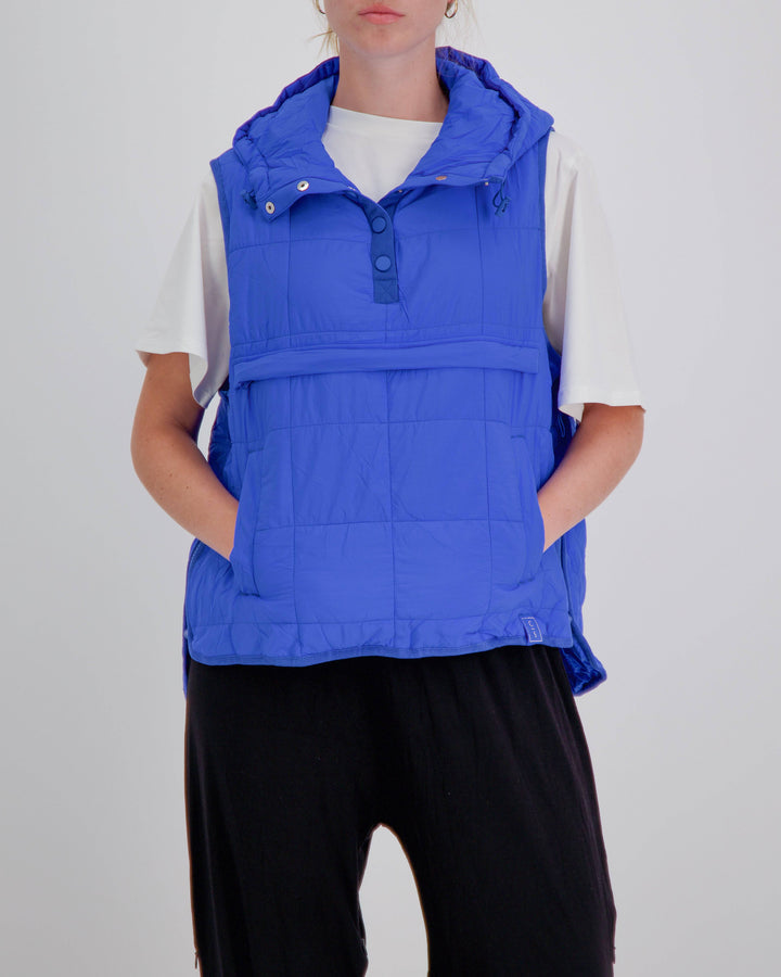 Blue adaptive puffer vest by Christina Stephens, designed for wheelchair users, showcasing a gender-neutral style.