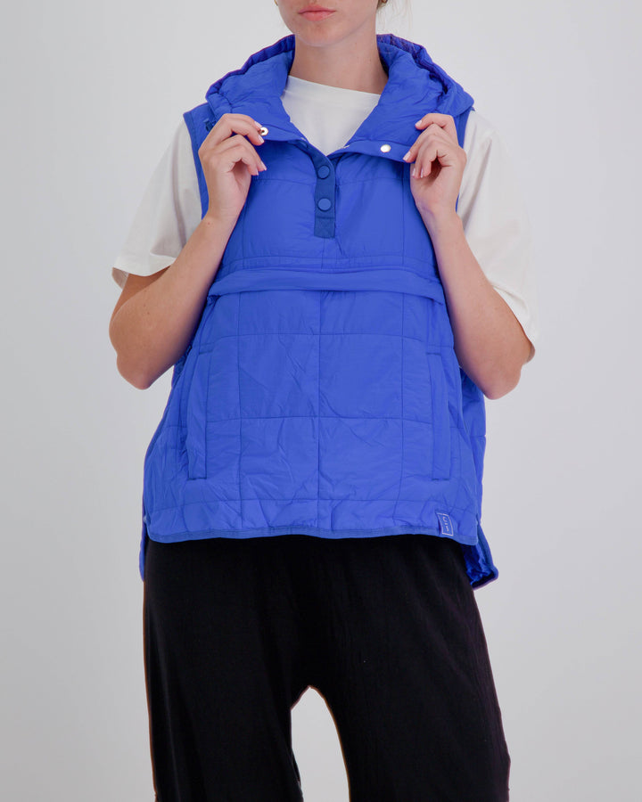 Blue adaptive puffer vest by Christina Stephens, designed for wheelchair users with a gender-neutral fit.