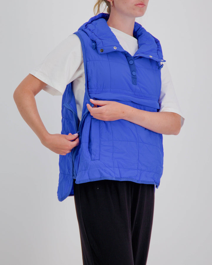 Blue adaptive puffer vest by Christina Stephens designed for wheelchair users, featuring a gender-neutral style and universal fit.
