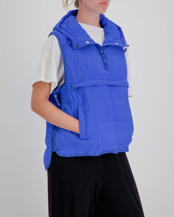 Blue adaptive puffer vest by Christina Stephens, designed for wheelchair users with a gender-neutral fit.