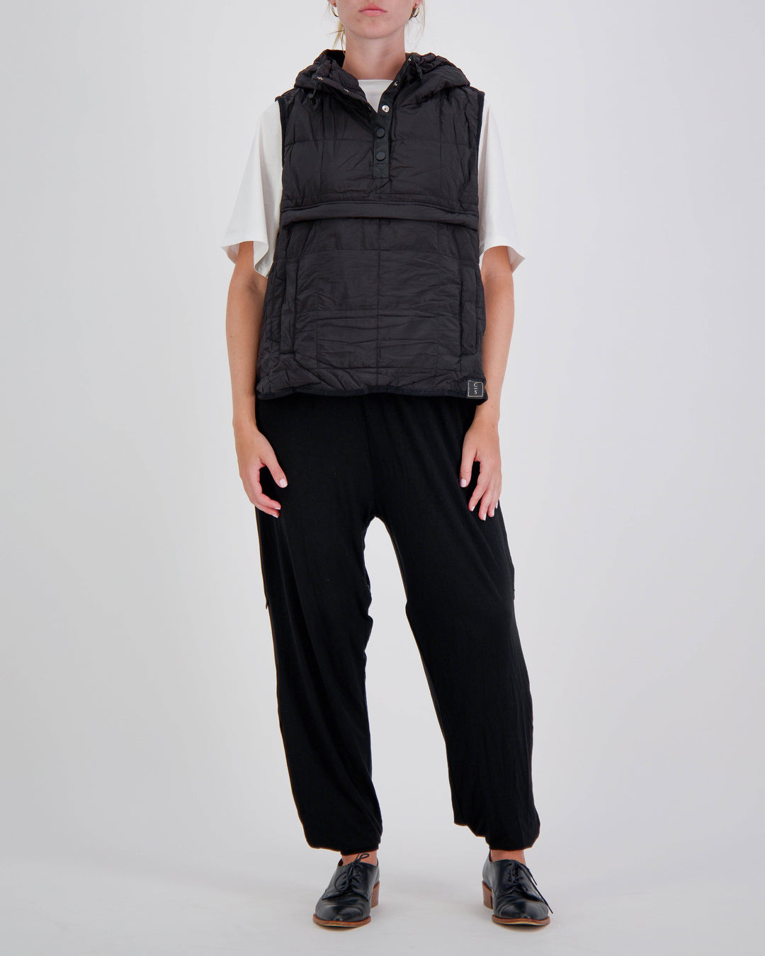 Black adaptive puffer vest by Christina Stephens, designed for wheelchair users with a gender-neutral fit.