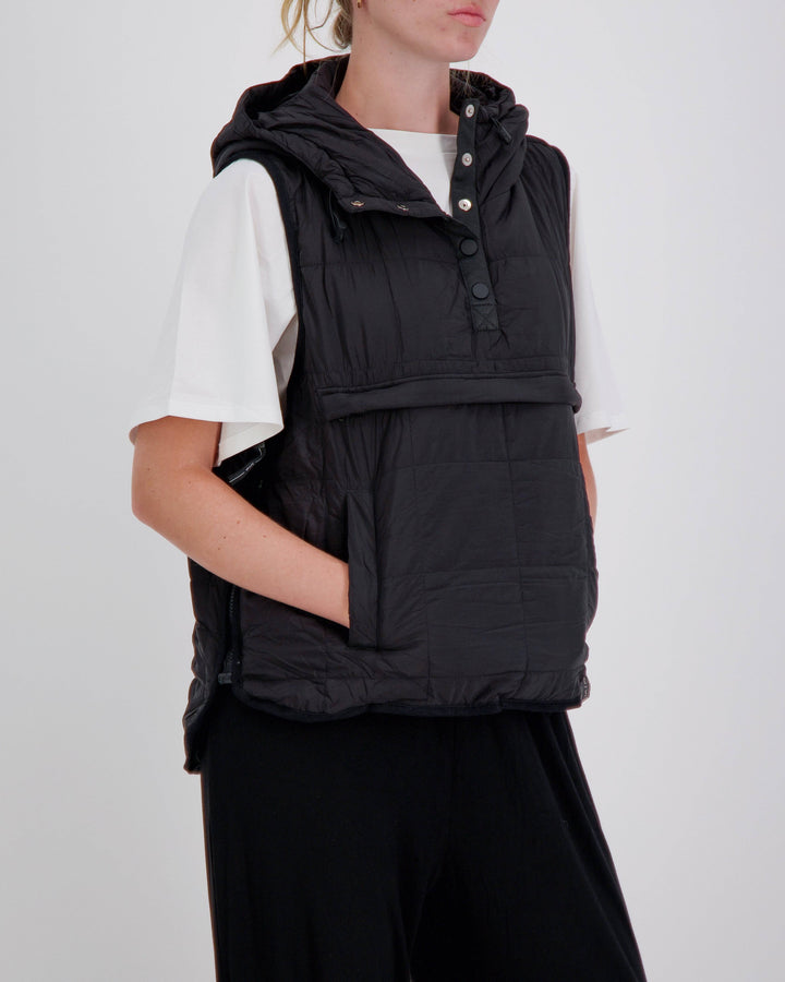 Black adaptive puffer vest by Christina Stephens, designed for wheelchair users with a gender-neutral fit.