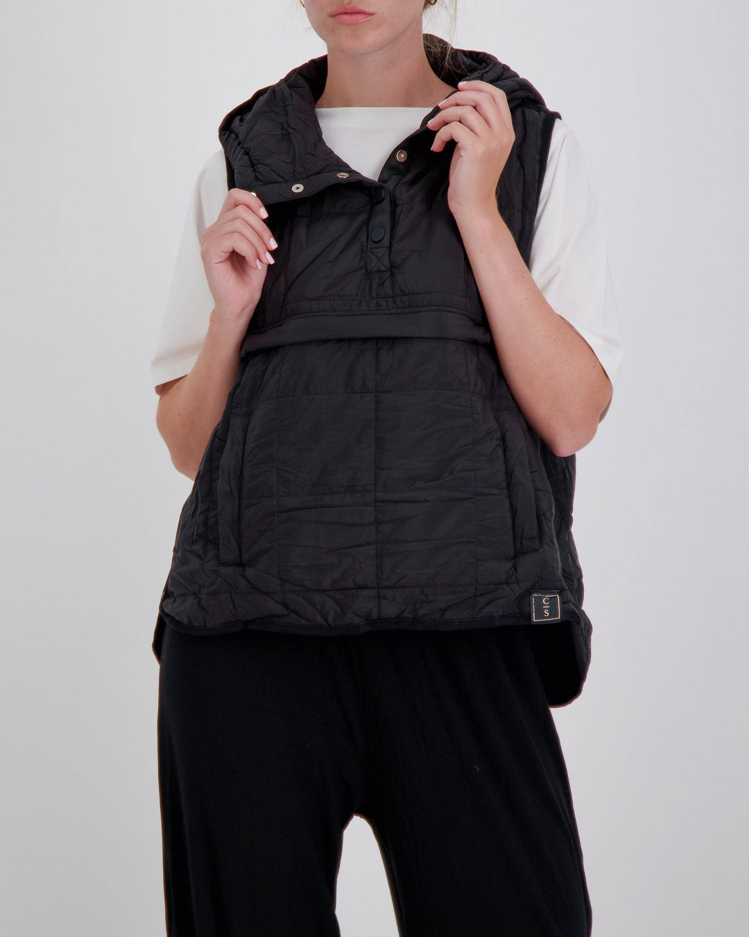 Black adaptive puffer vest by Christina Stephens designed for wheelchair users, featuring a gender-neutral universal design.