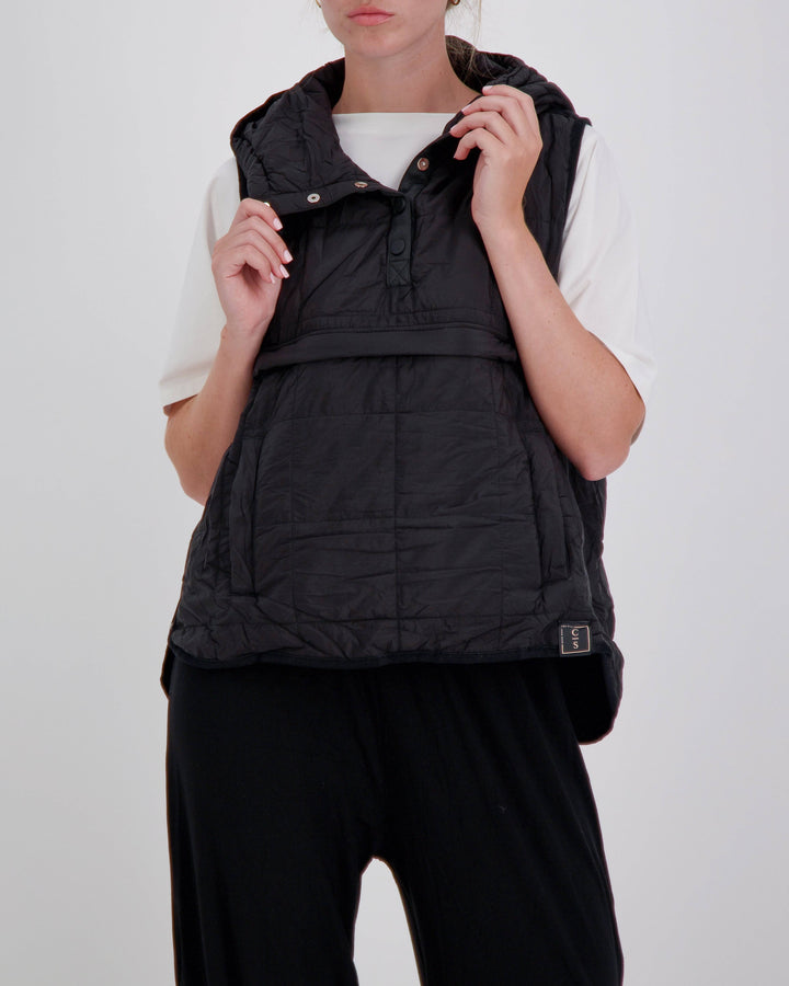 Black adaptive puffer vest by Christina Stephens designed for wheelchair users, featuring a gender-neutral universal design.