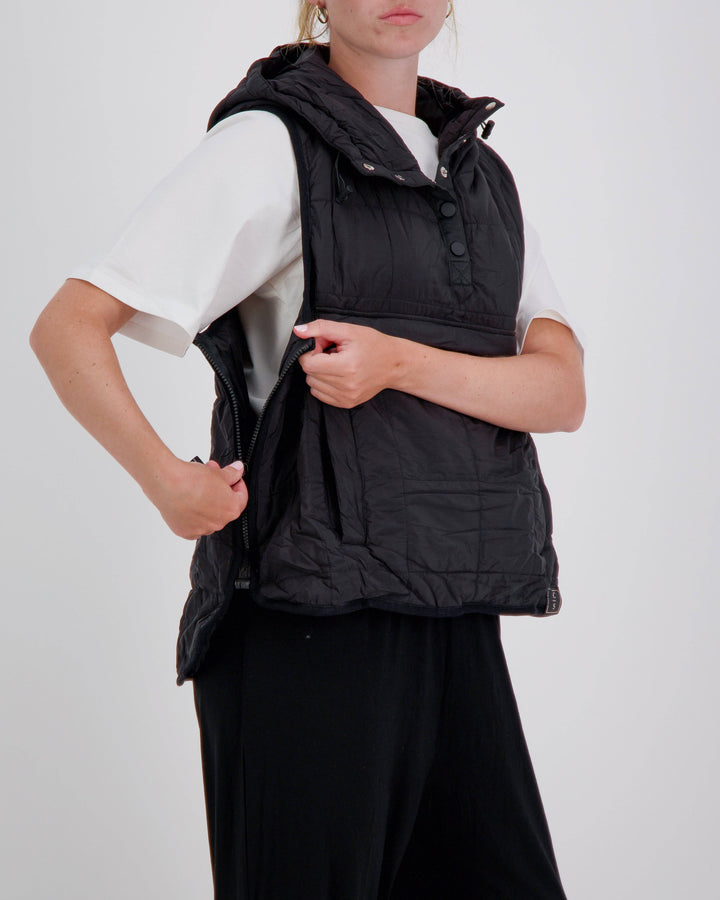Black adaptive puffer vest for wheelchair users by Christina Stephens, featuring a gender-neutral design and universal fit.
