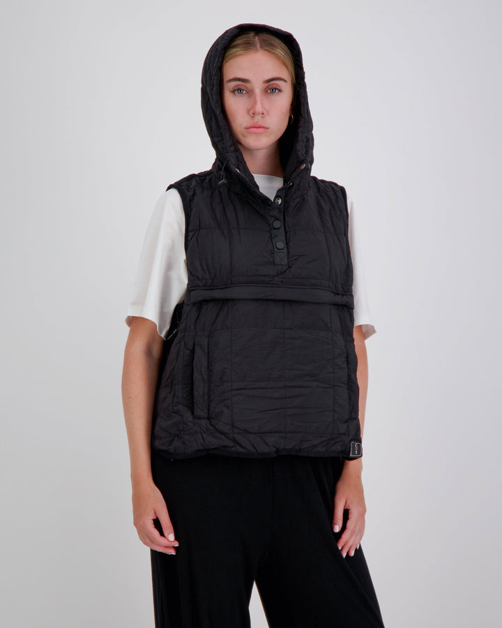 Black adaptive puffer vest by Christina Stephens designed for wheelchair users, featuring a gender-neutral style and universal fit.