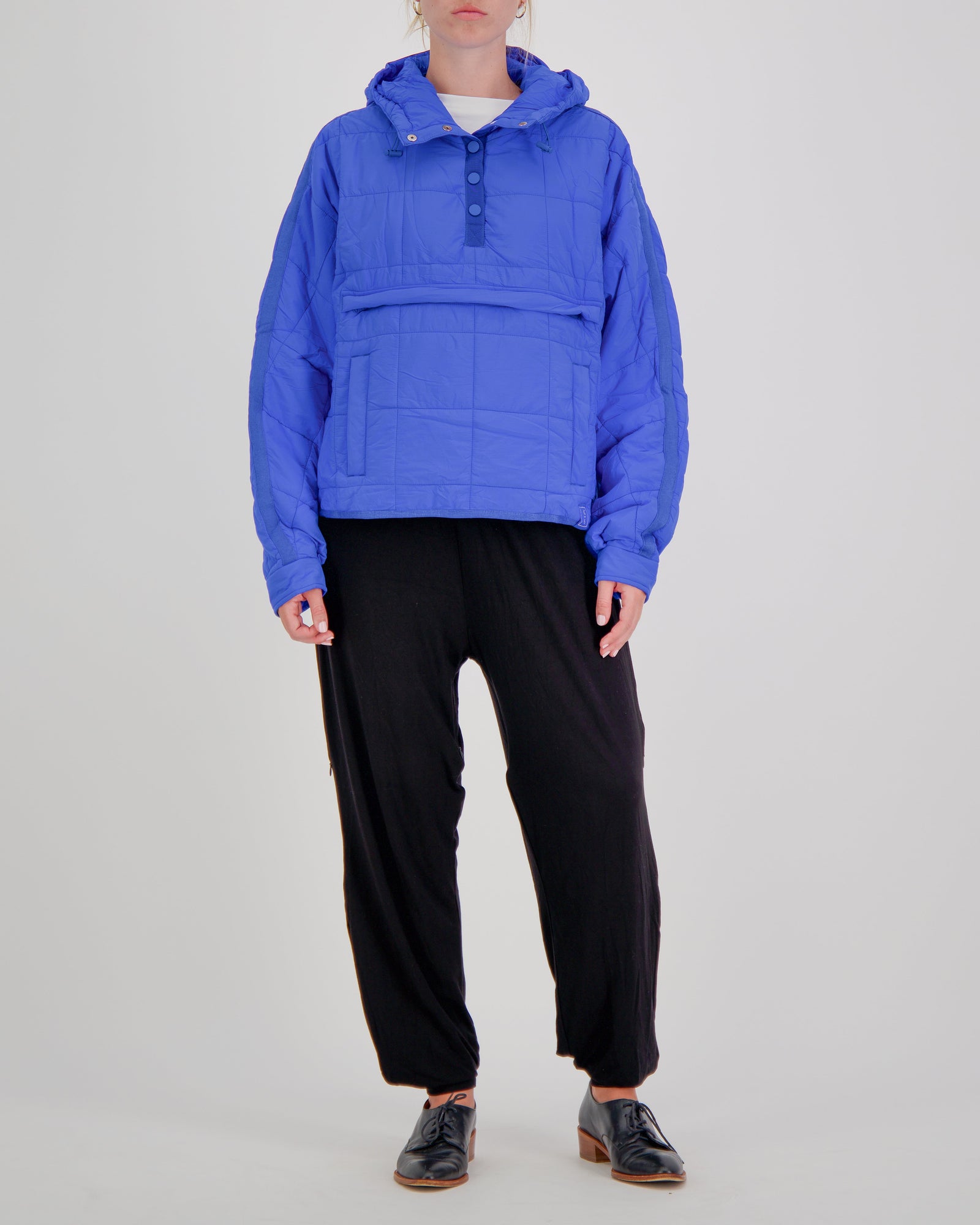 Blue adaptive puffer jacket by Christina Stephens, designed for wheelchair users with a comfortable fit and stylish look.
