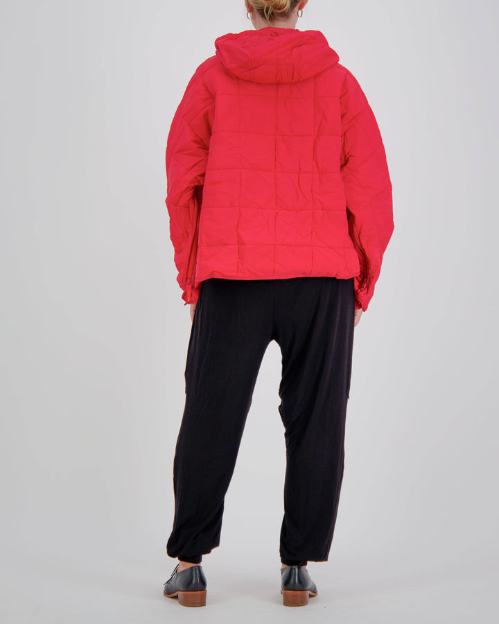 Red adaptive puffer jacket by Christina Stephens designed for wheelchair users, featuring a stylish and functional design.