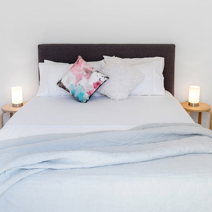 Conni X-wide white bed pad with tuck-ins, designed for comfort and protection in Manchester bedding.