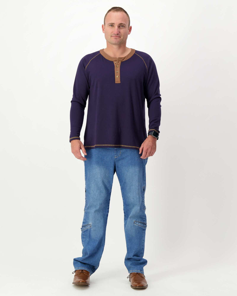 Standing male is wearing a bamboo long sleeve raglan style t-shirt with jeans. Christina Stephens Adaptive Clothing Australia.