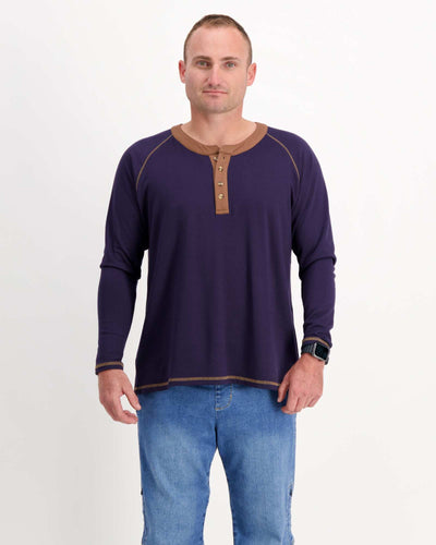 Standing male is wearing a bamboo long sleeve raglan style t-shirt with jeans. Christina Stephens Adaptive Clothing Australia.