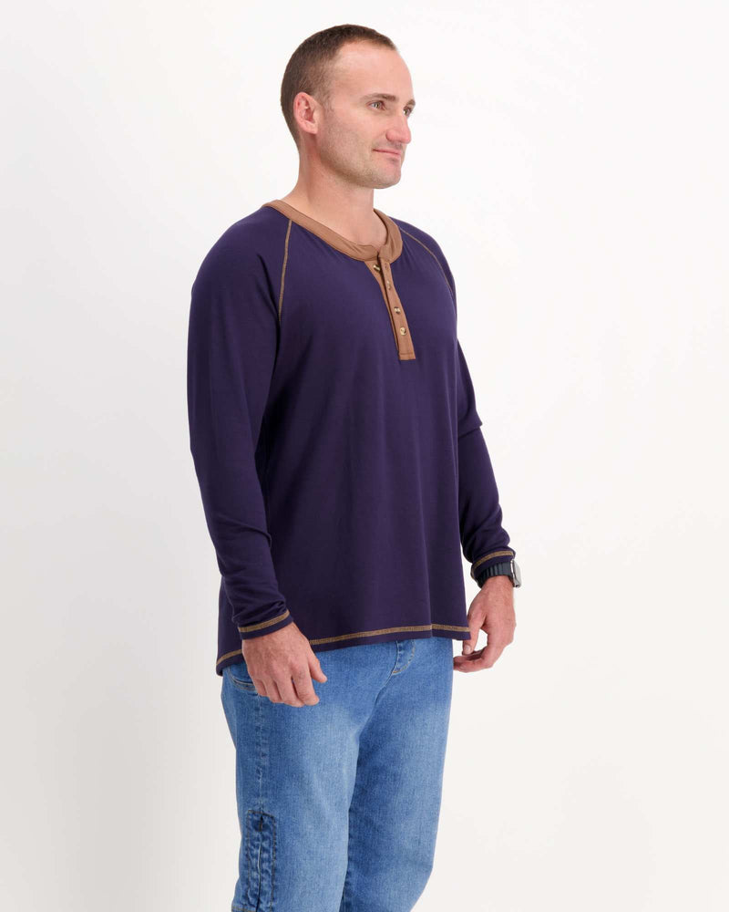 Standing male is wearing a bamboo long sleeve raglan style t-shirt with jeans. Christina Stephens Adaptive Clothing Australia.