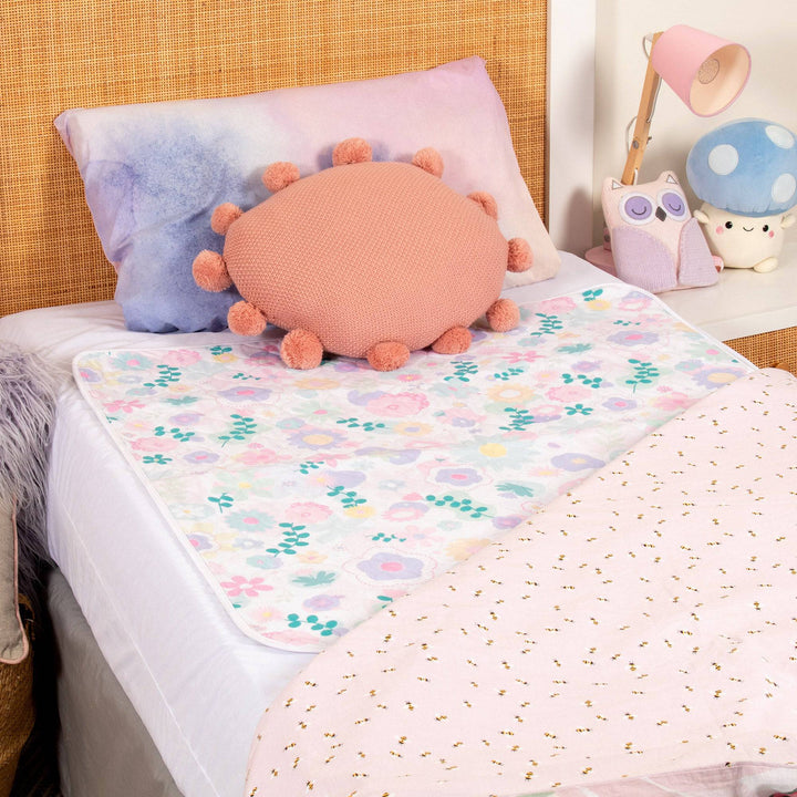 Conni Kids bed pad with flower print, soft cotton Manchester fabric, designed for children’s bedding protection.