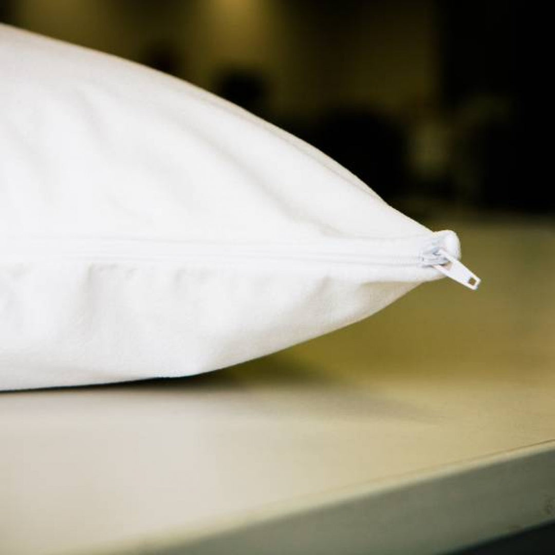 Conni Micro-Plush pillow protector in white, showcasing its soft texture and snug fit for standard pillows.
