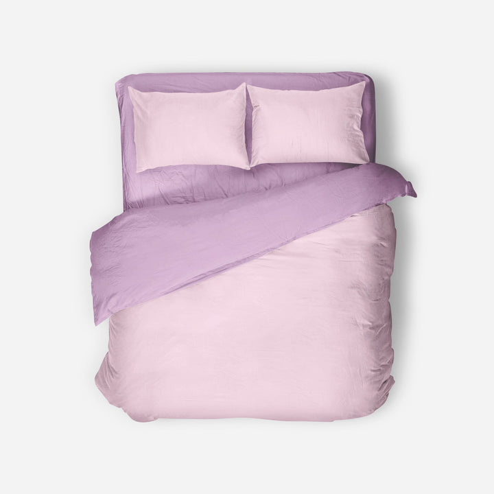 Purple bedding set with two pillows on a white background