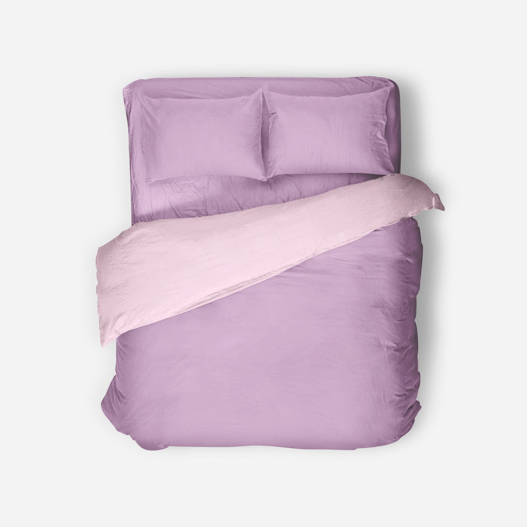 Purple bedding set with a matching pillow on a white background