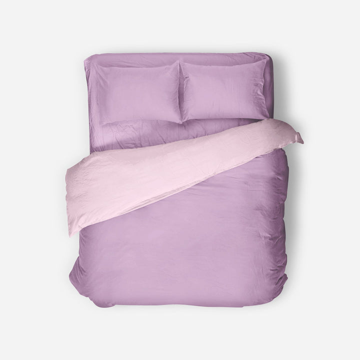 Purple bedding set with a matching pillow on a white background