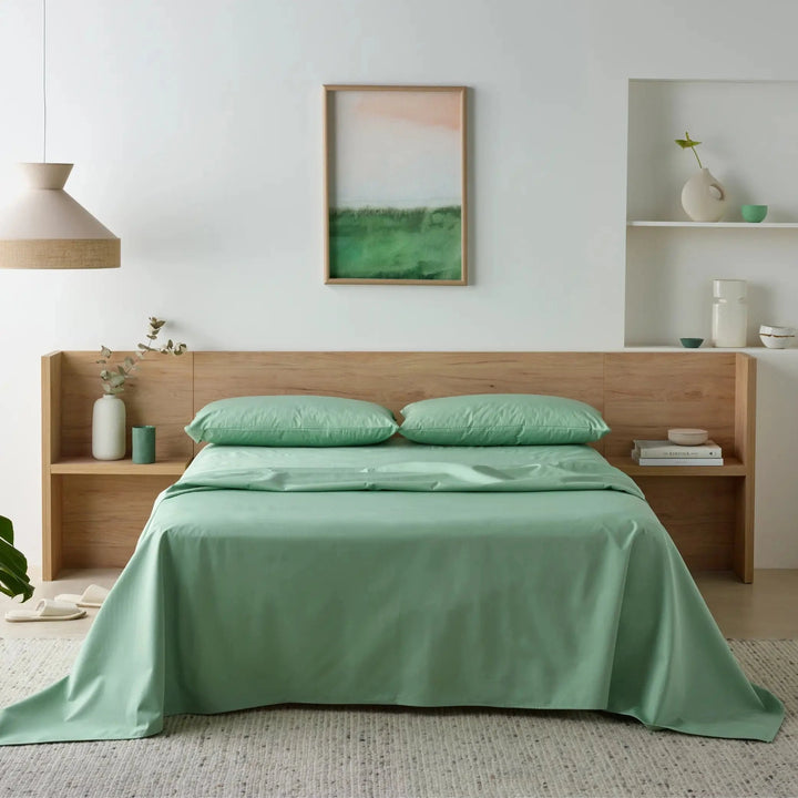 Staydry Forest Check Incontinence Bundle featuring a green waterproof bamboo fitted sheet on a bed.