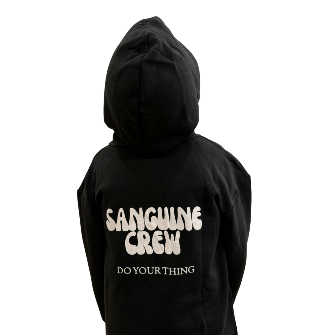 Kids wearing a Sanguine Crew hoodie, showing the back design and soft fabric in a casual outdoor setting.