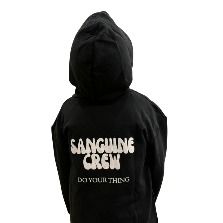 Kids wearing a Sanguine Crew hoodie, showing the back design and soft fabric in a casual outdoor setting.