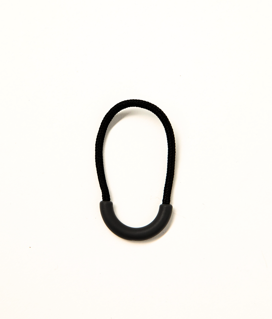 Black clothing zip puller from JAM the Label, featuring a sleek design and durable metal zipper for stylish, functional wear.