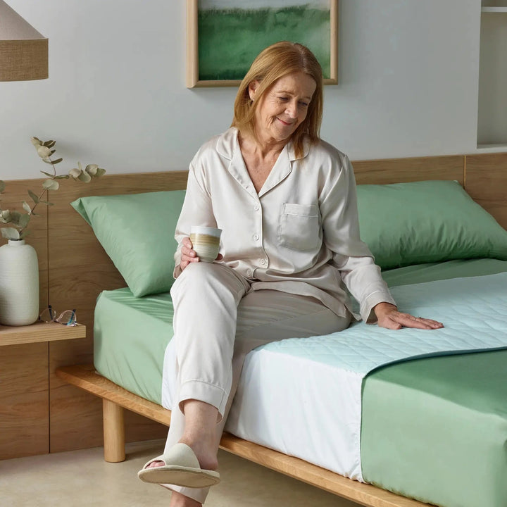 Lightweight Staydry bed pad in blue with forest check pattern, designed for incontinence support and comfort.