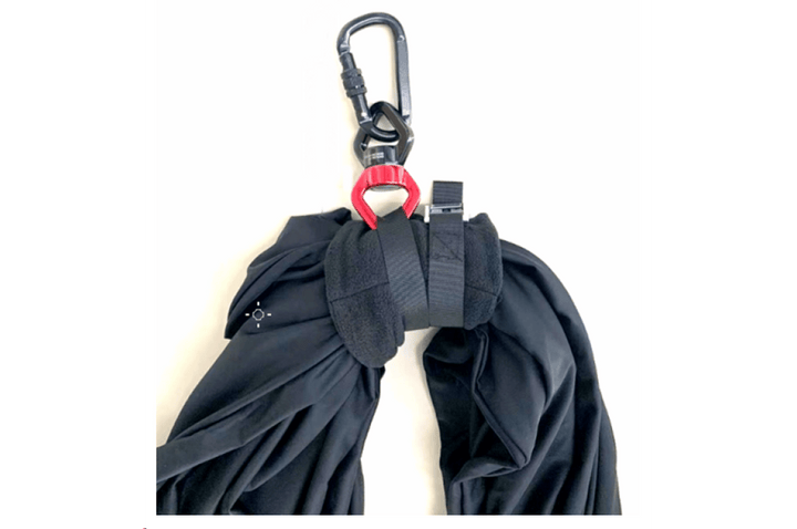 Black Lycra therapy sensory swing designed for play equipment by Special Needs Play Equipment, shown in a cozy indoor setting.