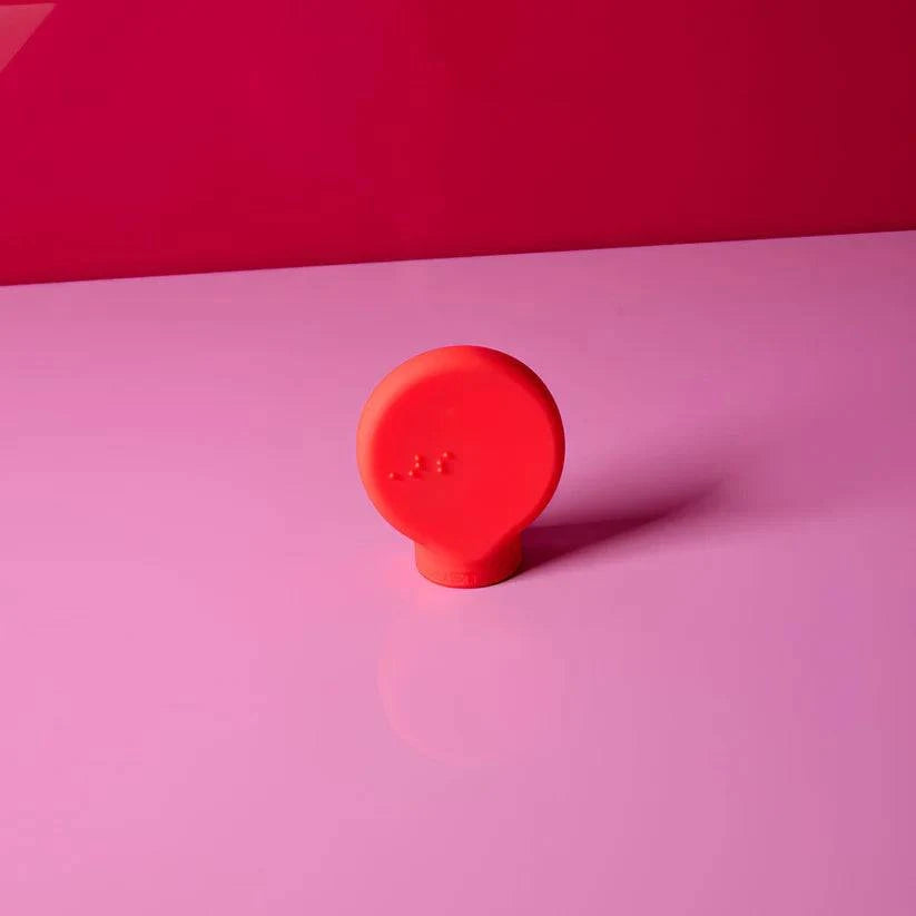 Red paddle-shaped Margie adaptive beauty tool by By Storm Beauty, designed for easier, precise makeup application.