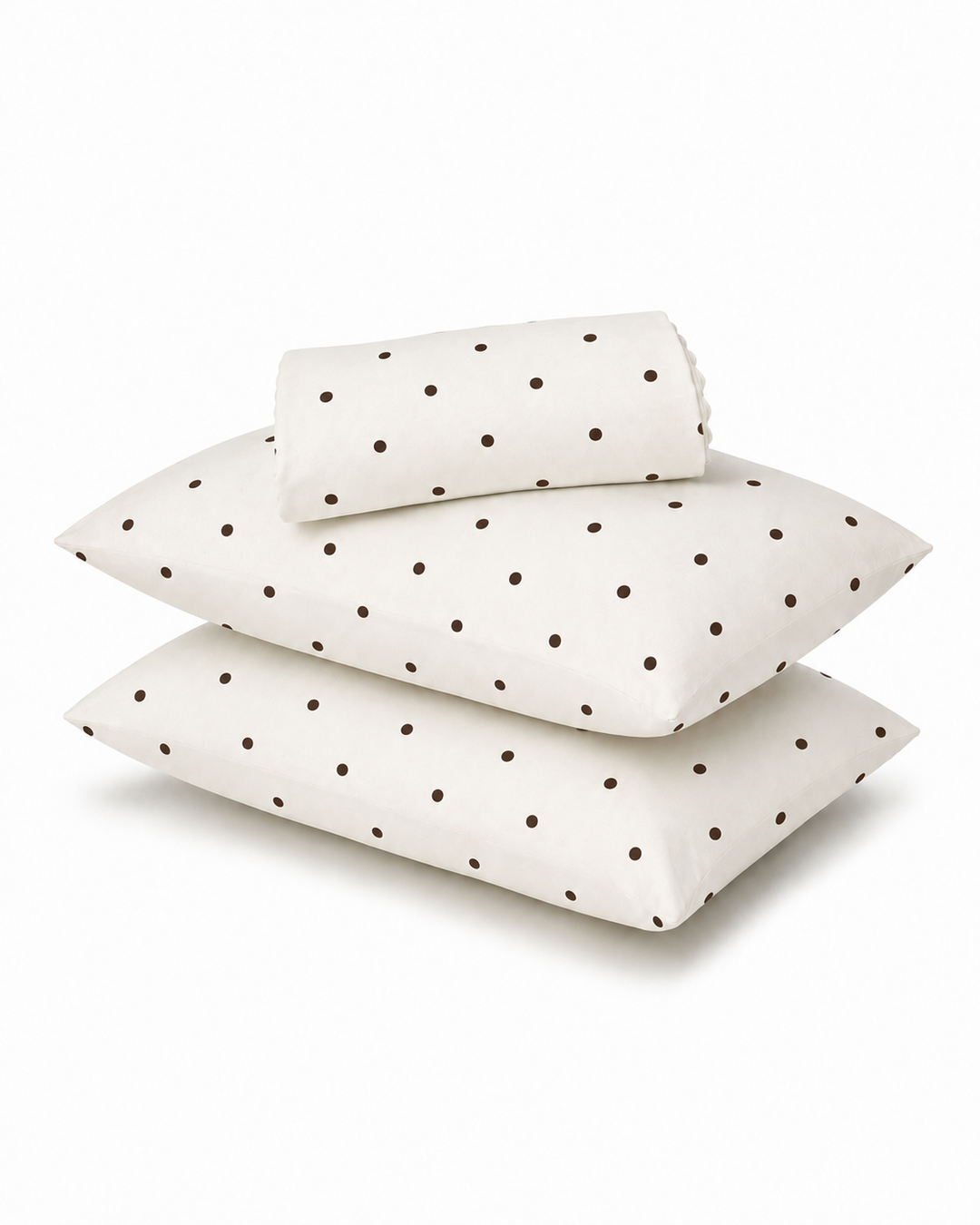 Three white pillows with a dark brown polka dot pattern, including two flat rectangular pillows and one rolled sheet, arranged on a clean white background.